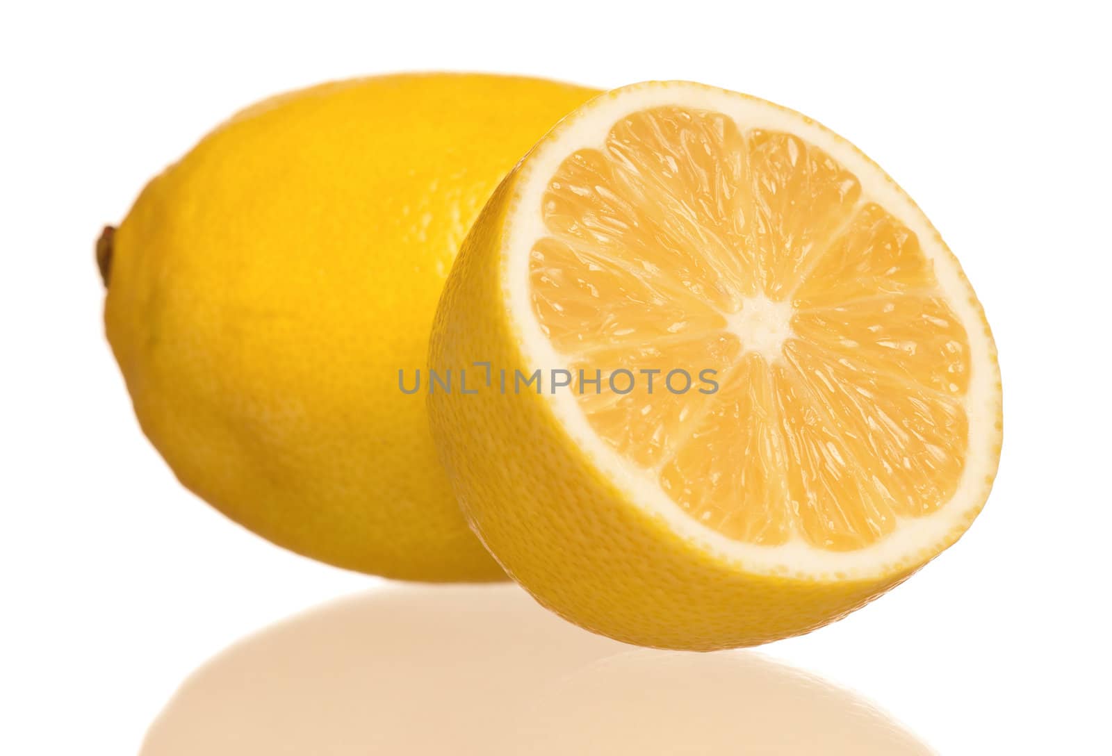 Fresh ripe lemon with half isolated on white background