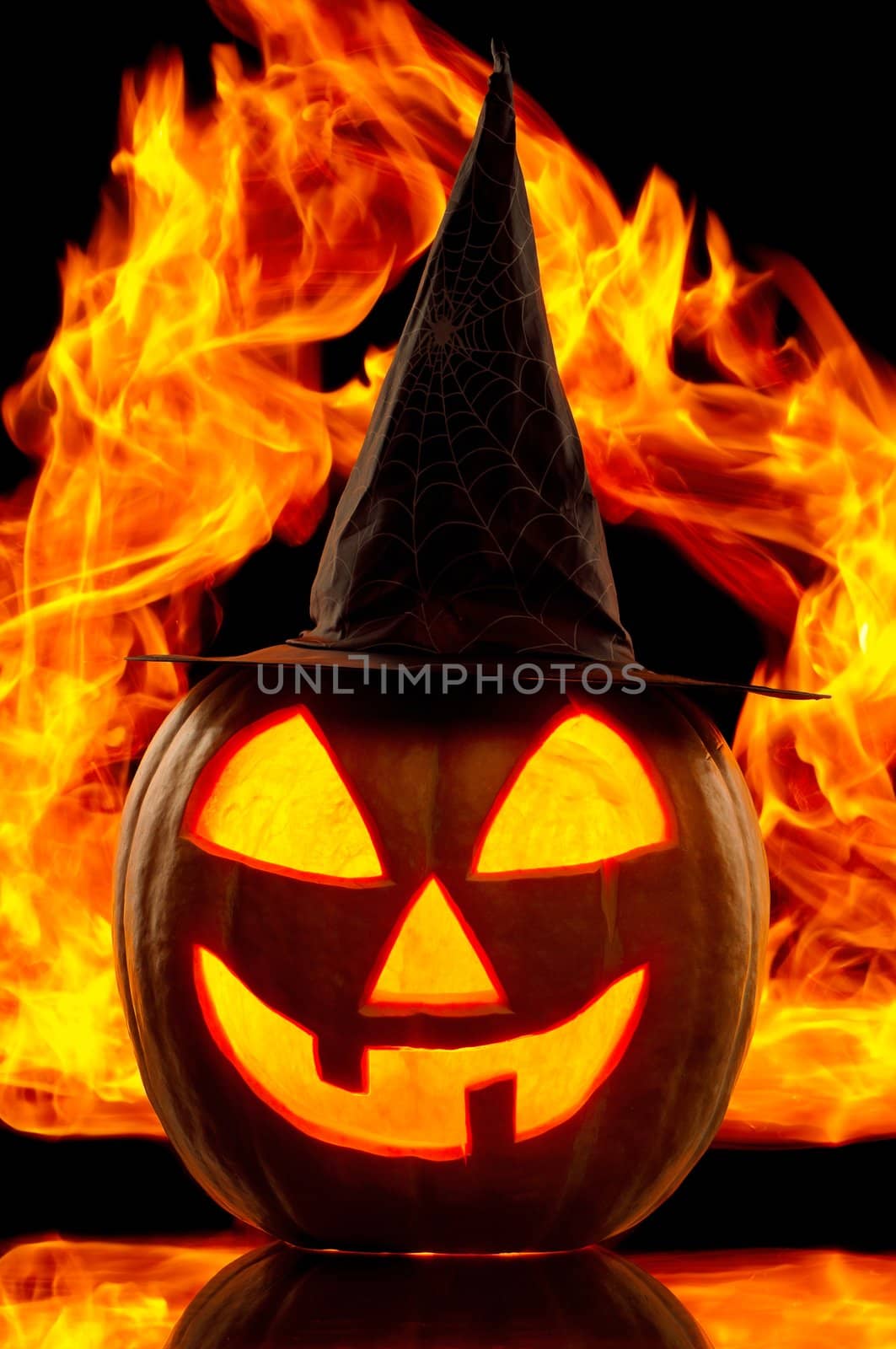 Funny Halloween pumpkin with black hat isolated on black background