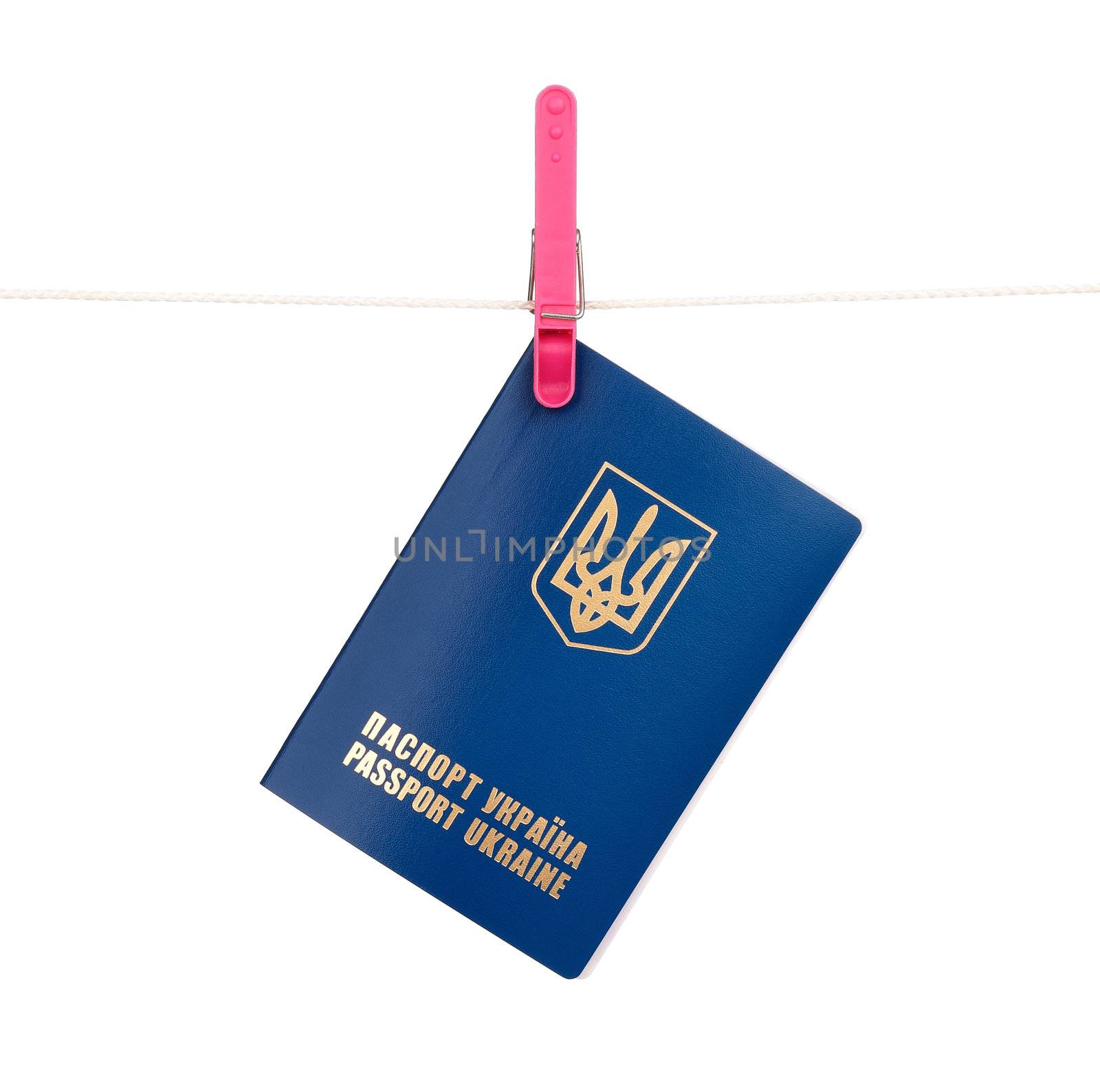 Clothes-peg holding international Ukrainian passport on a rope isolated on white background