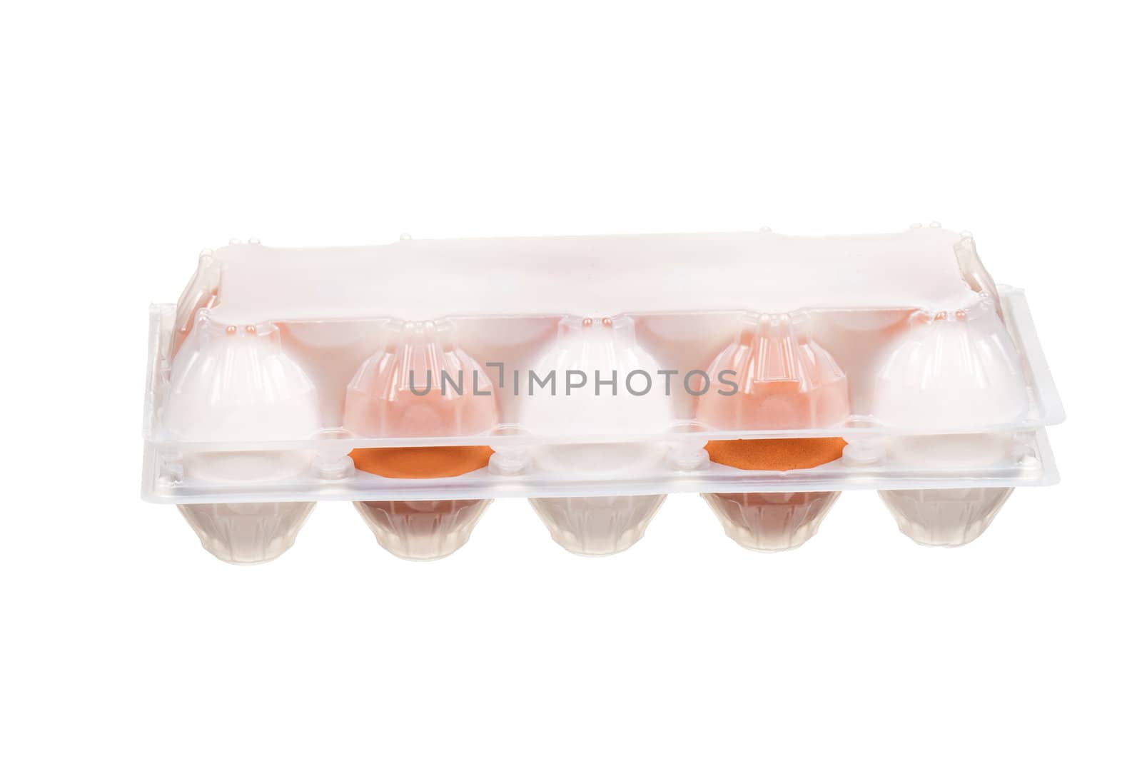 Brown and white eggs in the plastic box over white background