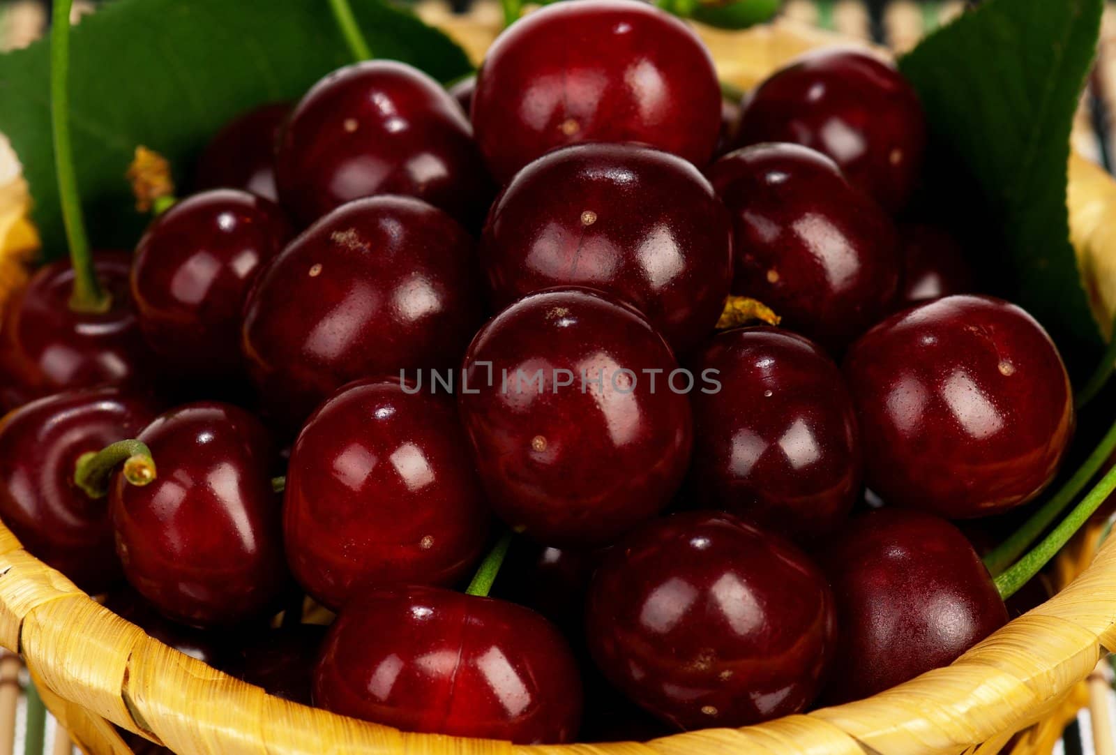 Sweet cherries in a basket on a white background