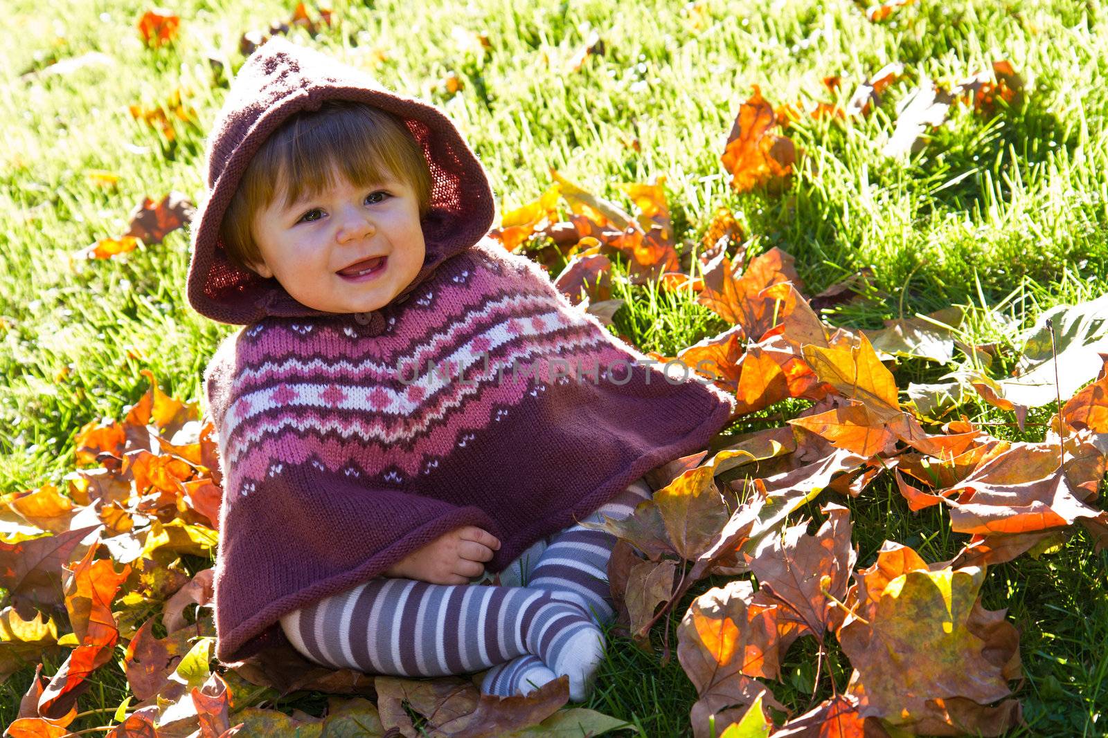 baby with autumn leaf