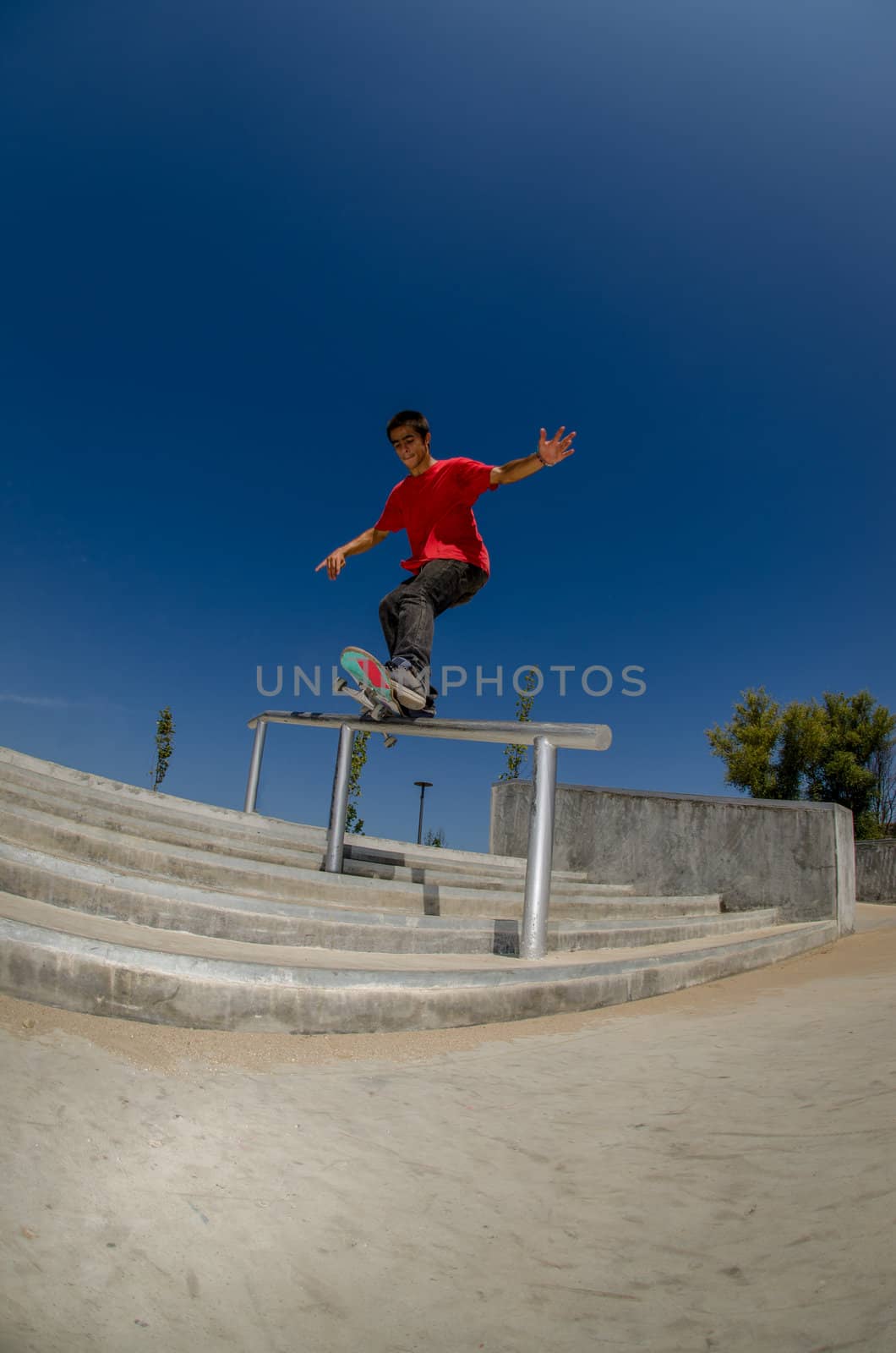 Skateboarder on a slide at the local skatepark.