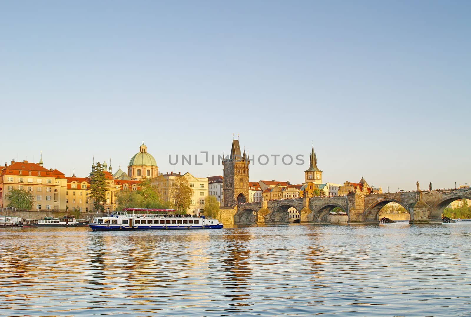 Charles Bridge of Prague with a boat on river Vltava