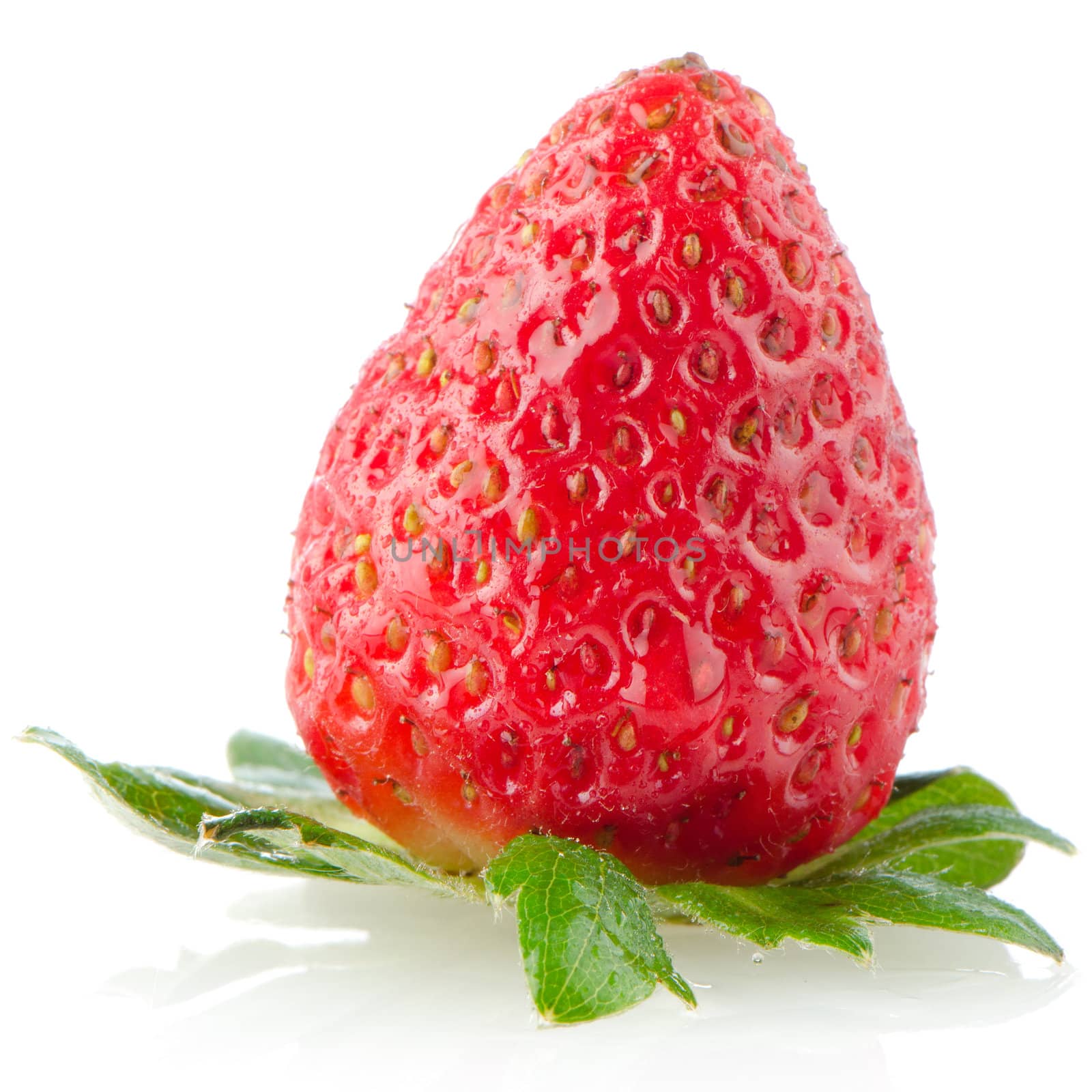 Fresh strawberry on a white reflective background.