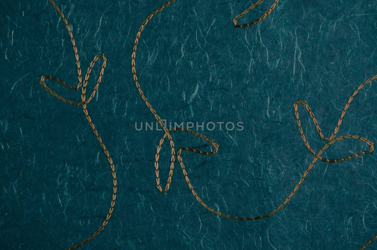Closeup detail of stitched green recycled paper.