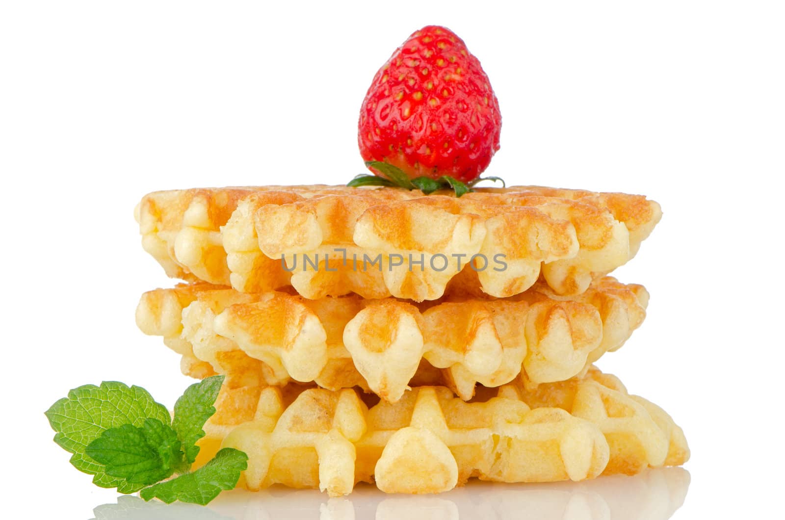 Waffles and strawberry isolated on white background.