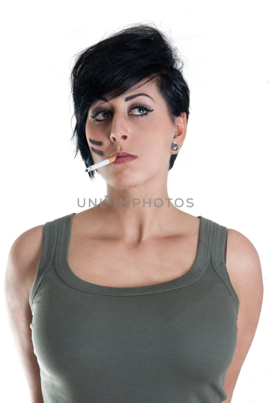 young woman in green top is smoking a cigarette - isolated on white background