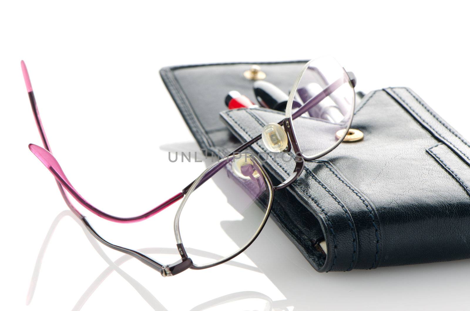 Leather notebook and glasses isolated on white background.