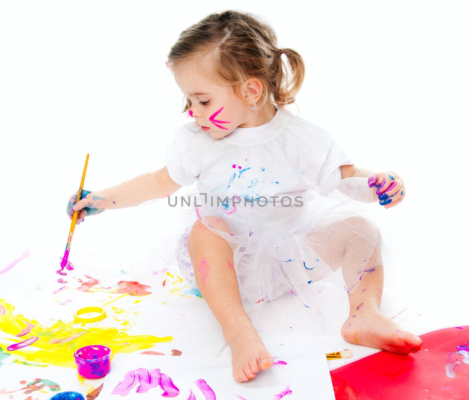 cute little girl with a brush and paints