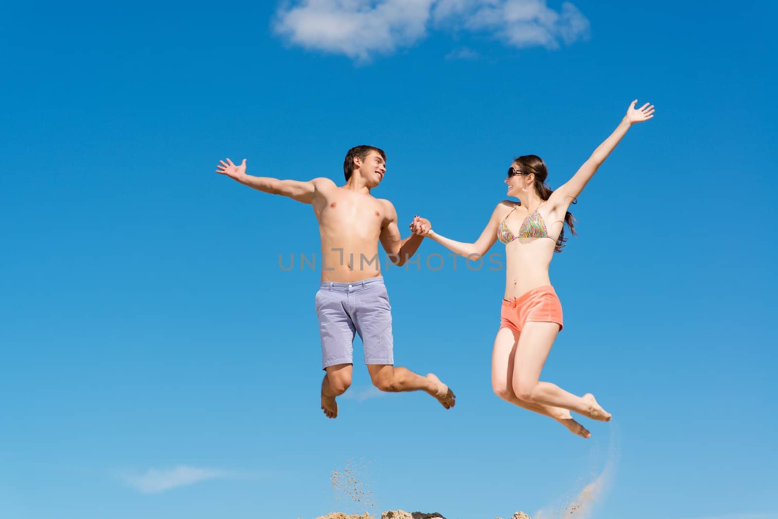 couple jumping together by adam121
