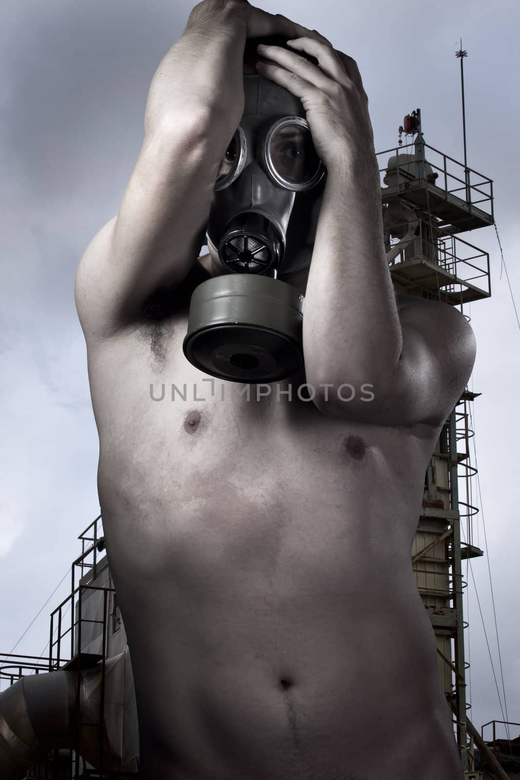 Man in a gas mask looking , industry at background