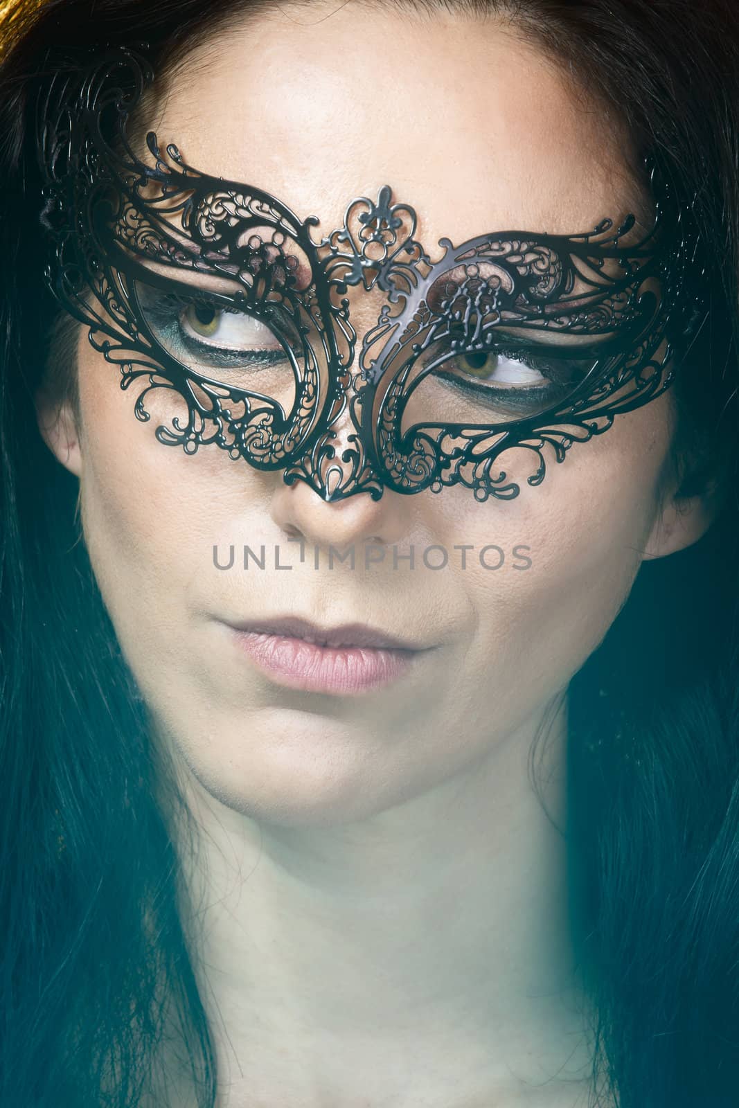 close-up portrait of beautiful brunette woman with carnival venetian mask