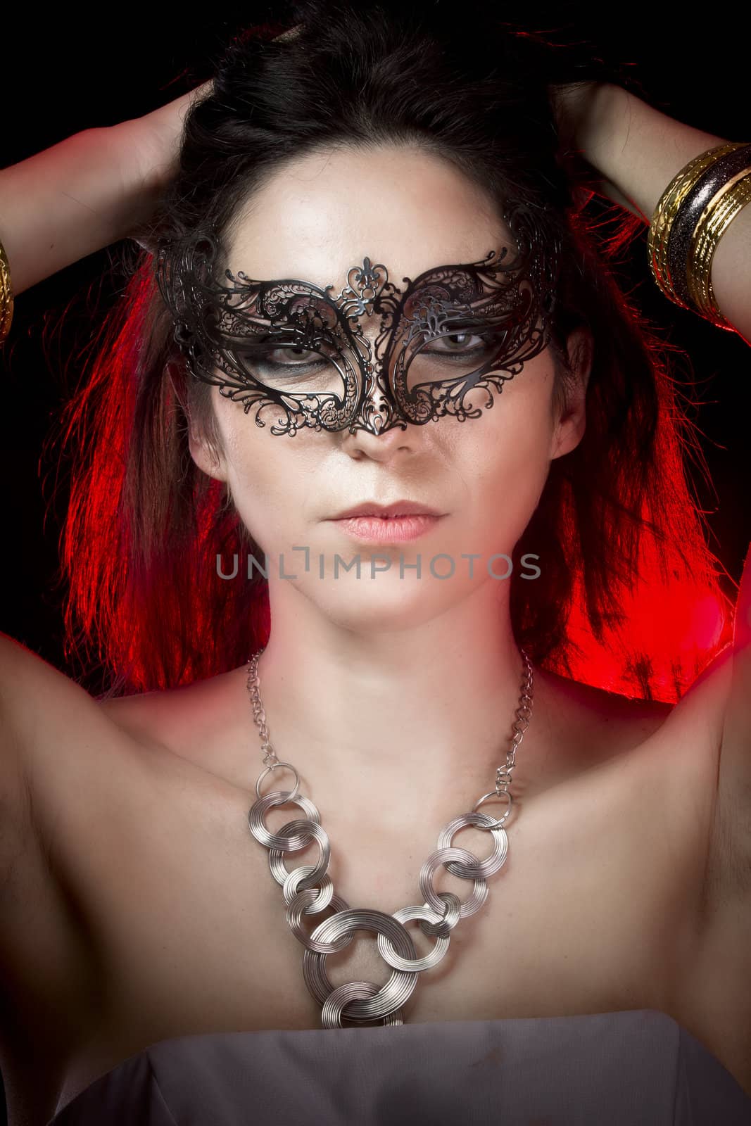 closeup portrait of sexy woman in red party light, venetian mask