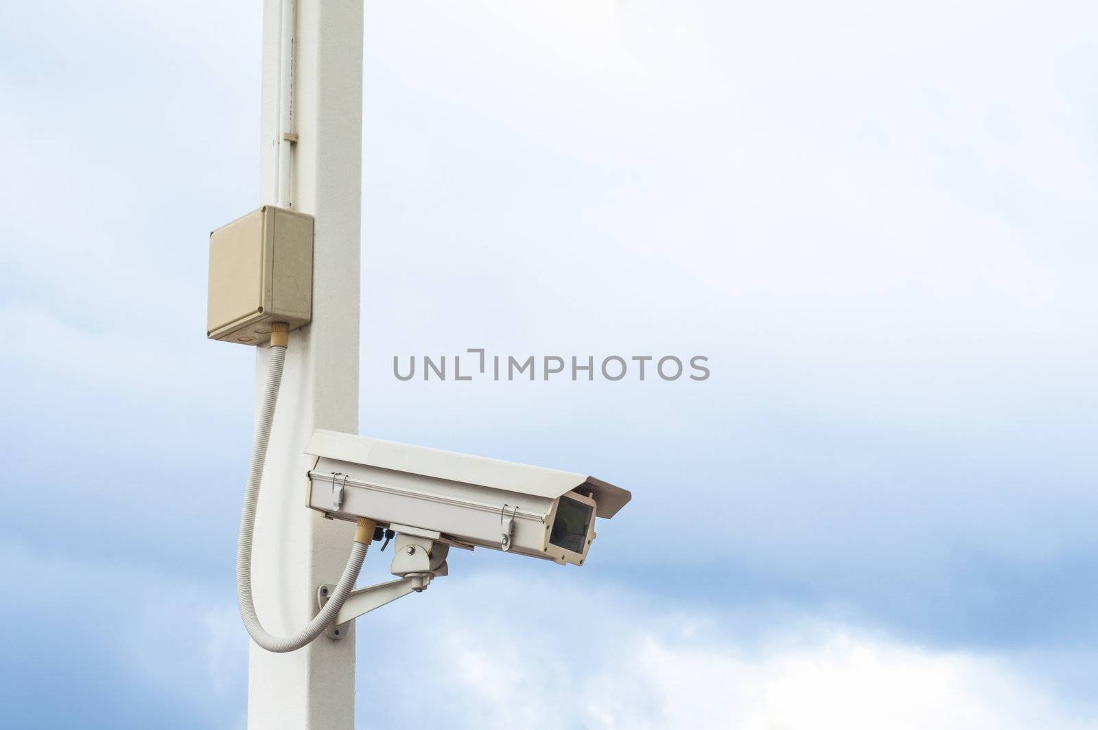 Security camera on the post with outdoor housing