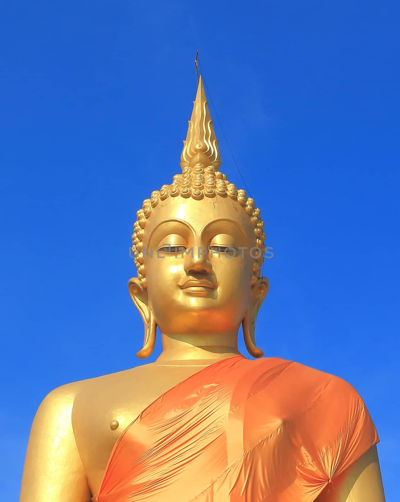 A golden buddha statue with a blue sky, Pathumthani, Thailand