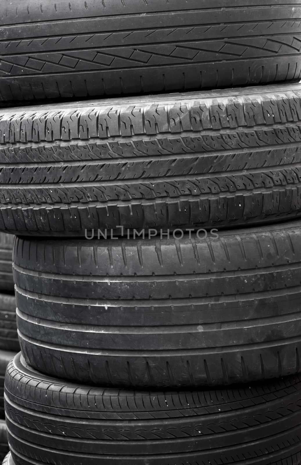 A stack of worn out rubber tire  by TanawatPontchour