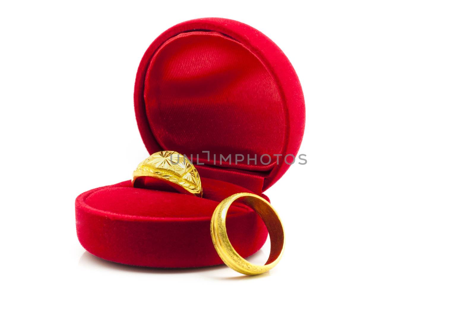 Red velvet box with golden rings