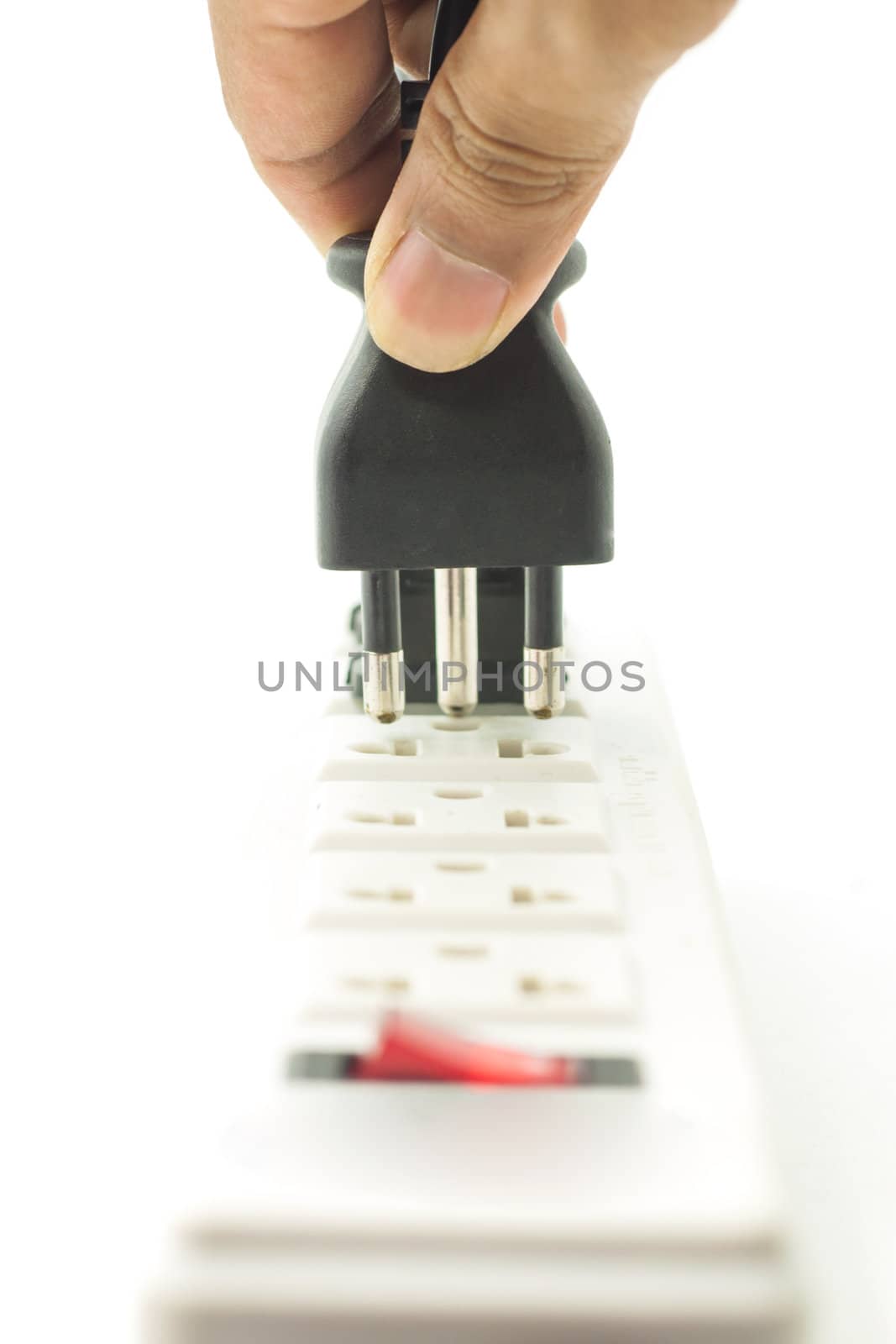 Hand pluging to power connector on white background