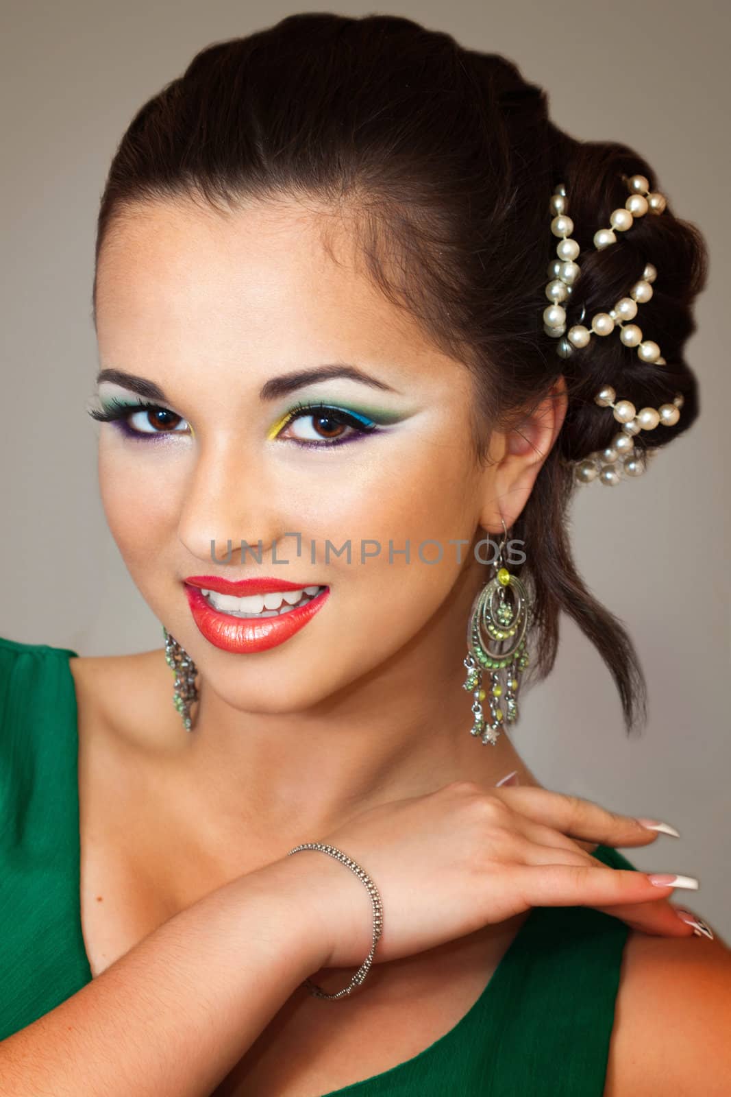 pretty brunette smiling and having an oriental makeup 