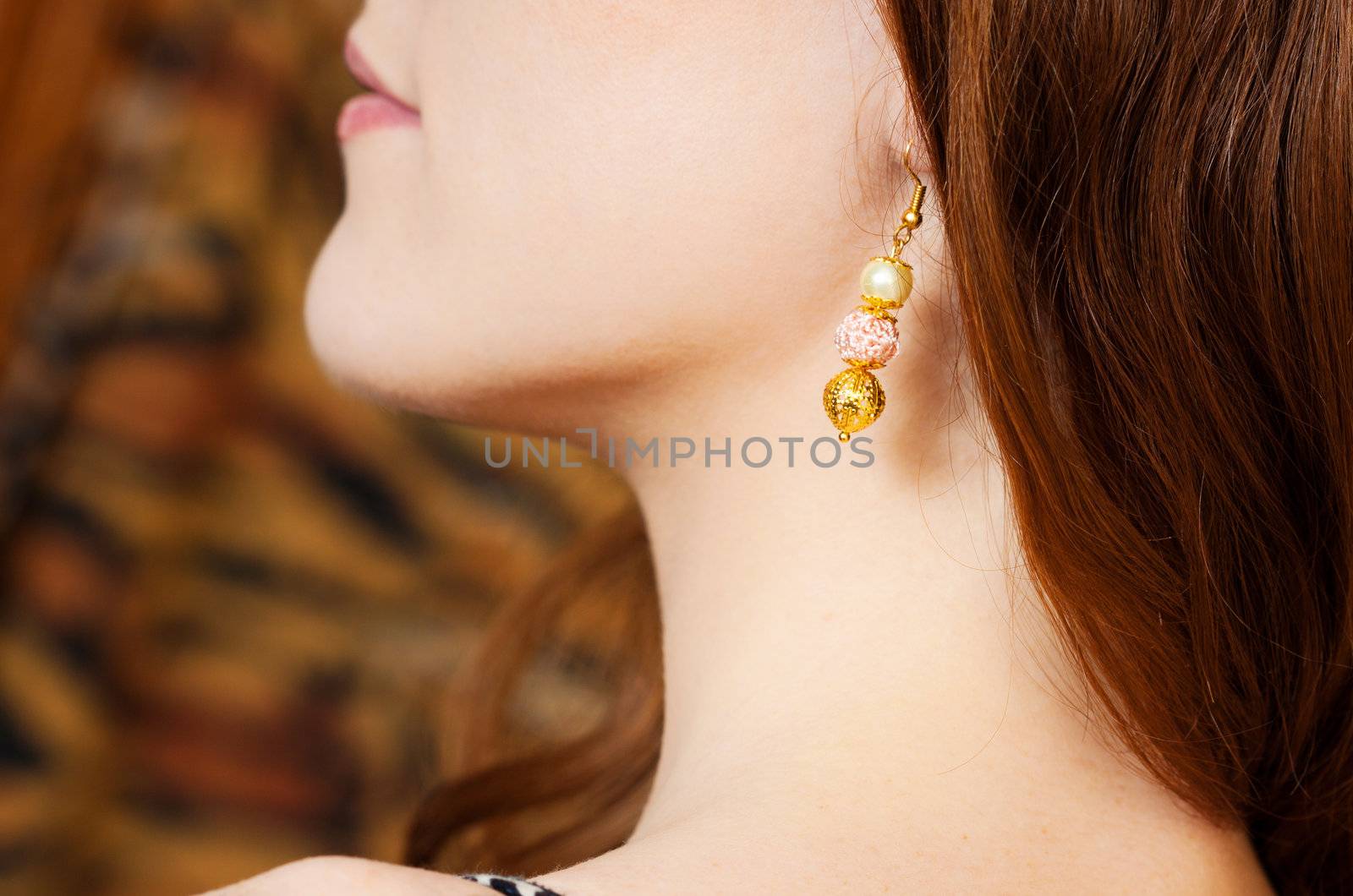 close up picture of redhead beauty wearing earings 