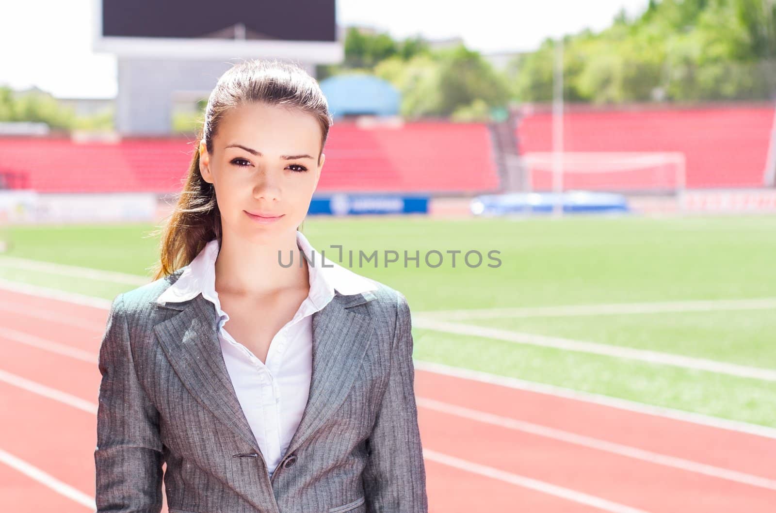 portrait of a beautiful business woman at a sports stadium, the competition in the business