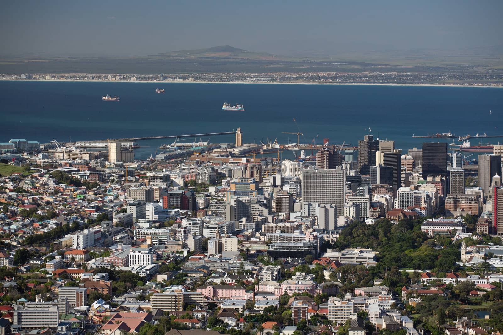 Aerial view of the city of Capetown showing the densely packed buildings and clear blue water in the background