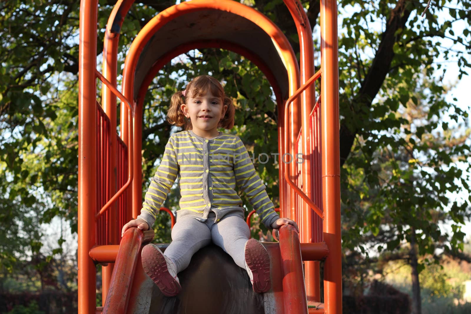 little girl on playground slide