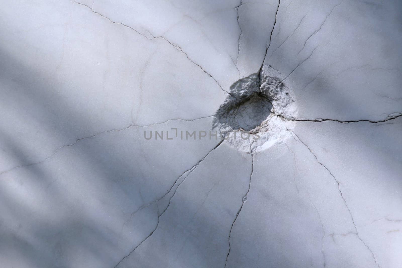 Bullet hole on the marble wall