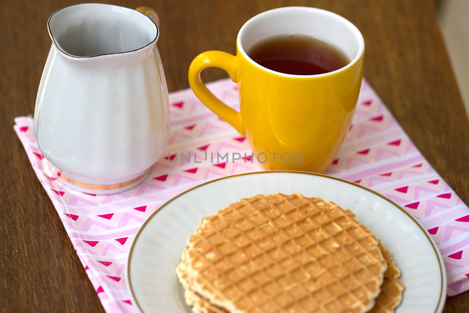 Round wafers with tea and honey for breakfast