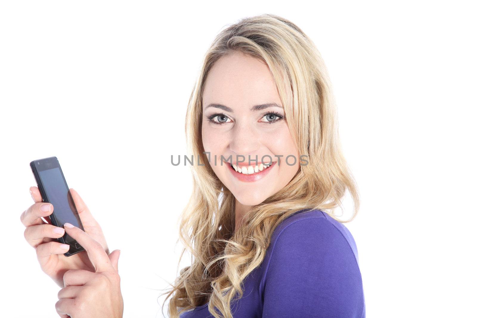 Friendly young blonde woman dialing on a cell phone isolated on white