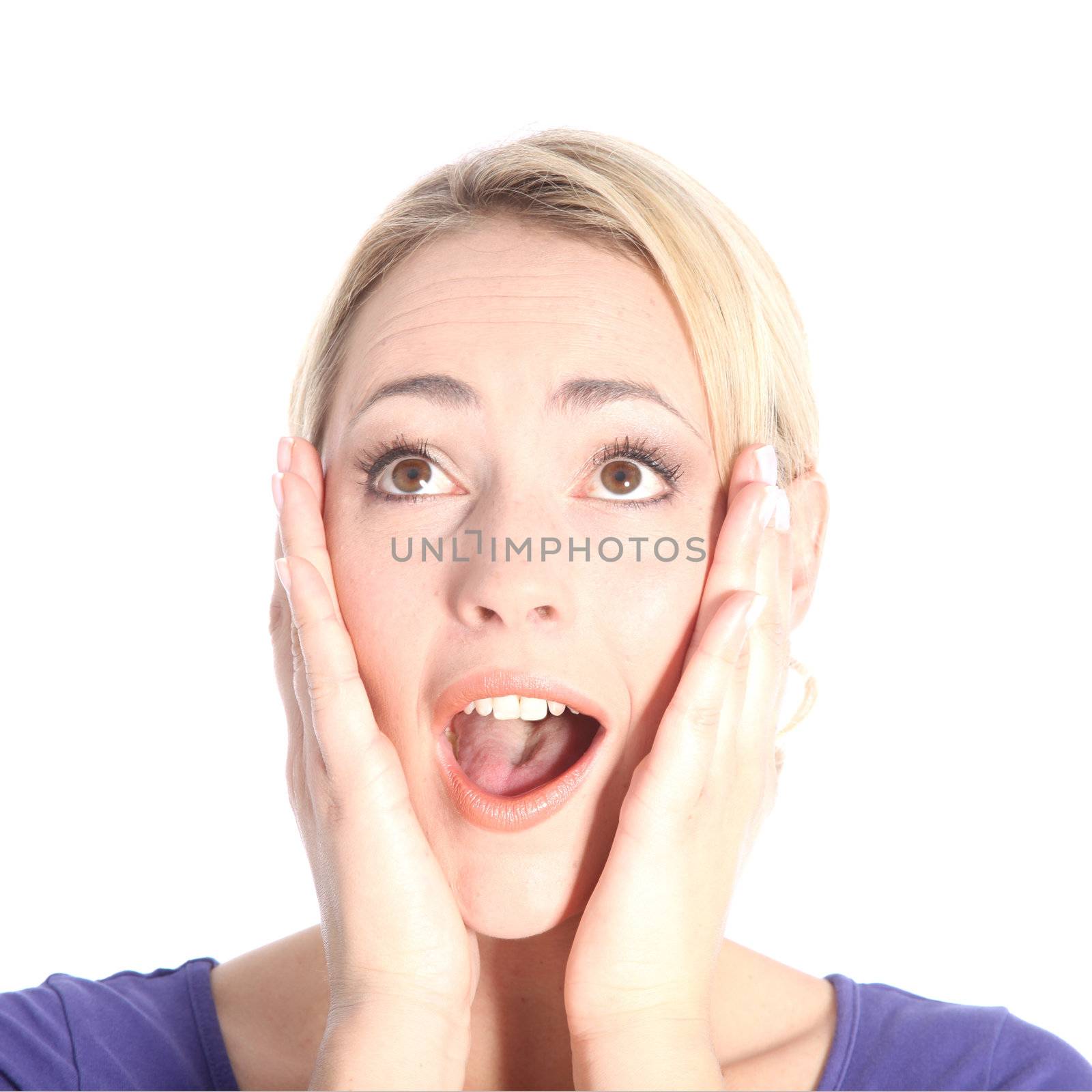 Portrait of beautiful surprised young blonde woman with hands on her face