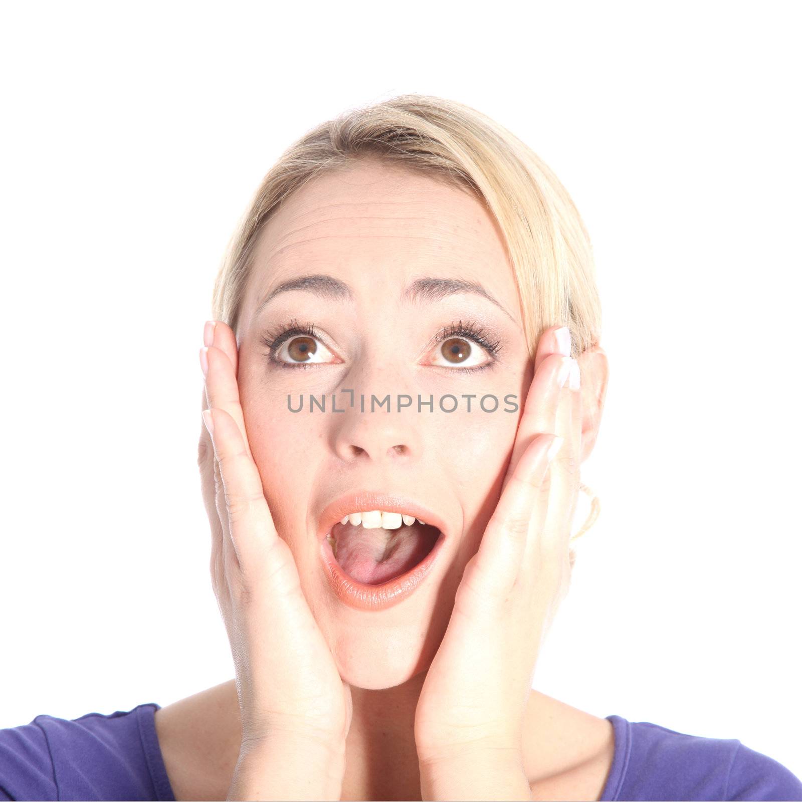 Portrait of beautiful surprised young blonde woman with hands on her face