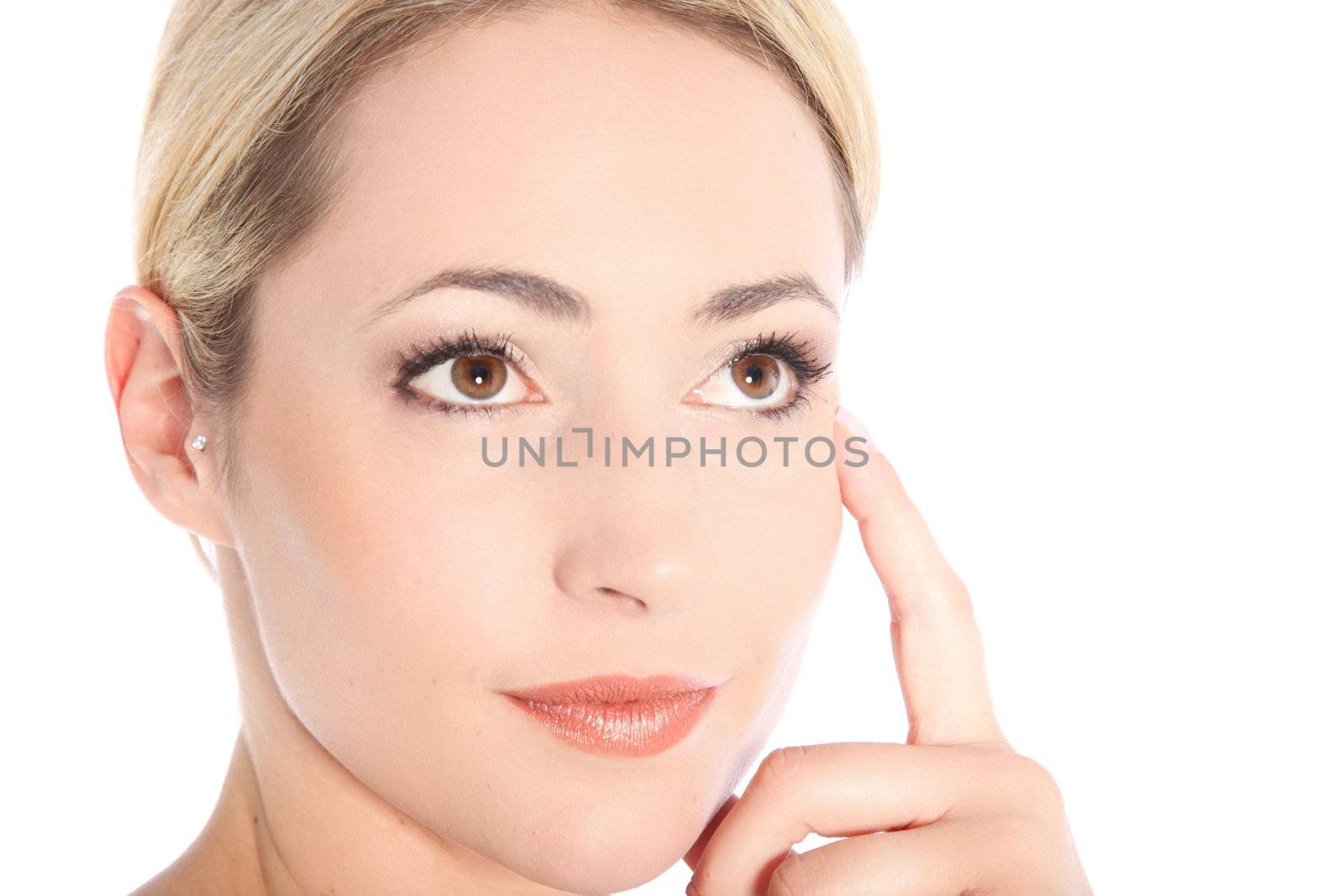 Studio portrait of beautiful young blonde woman touching her head with her finger and thinking