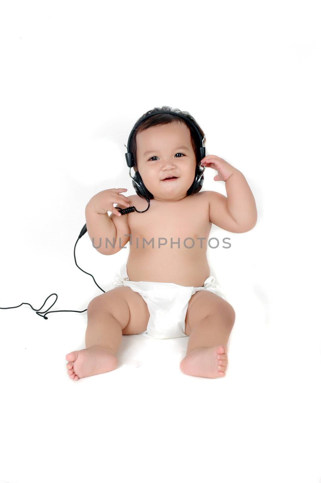 a chubby little girl listen to music with headphones isolated on white background
