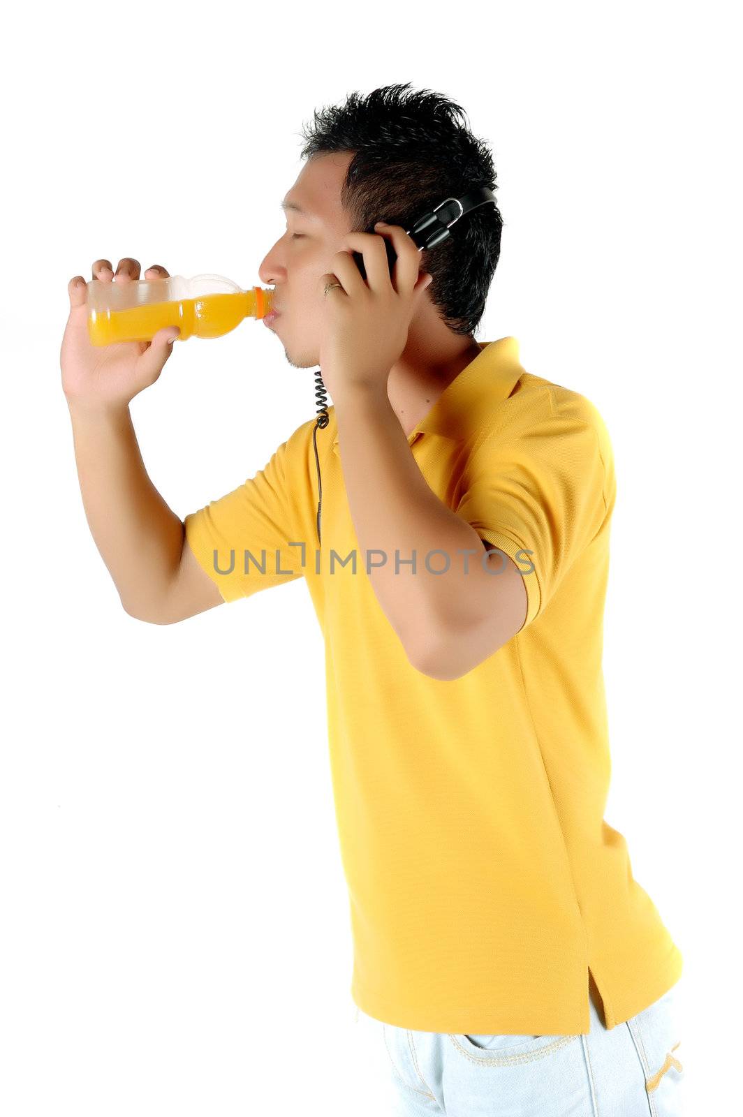 a young man was drinking a bottle of orange juice isolated on white background