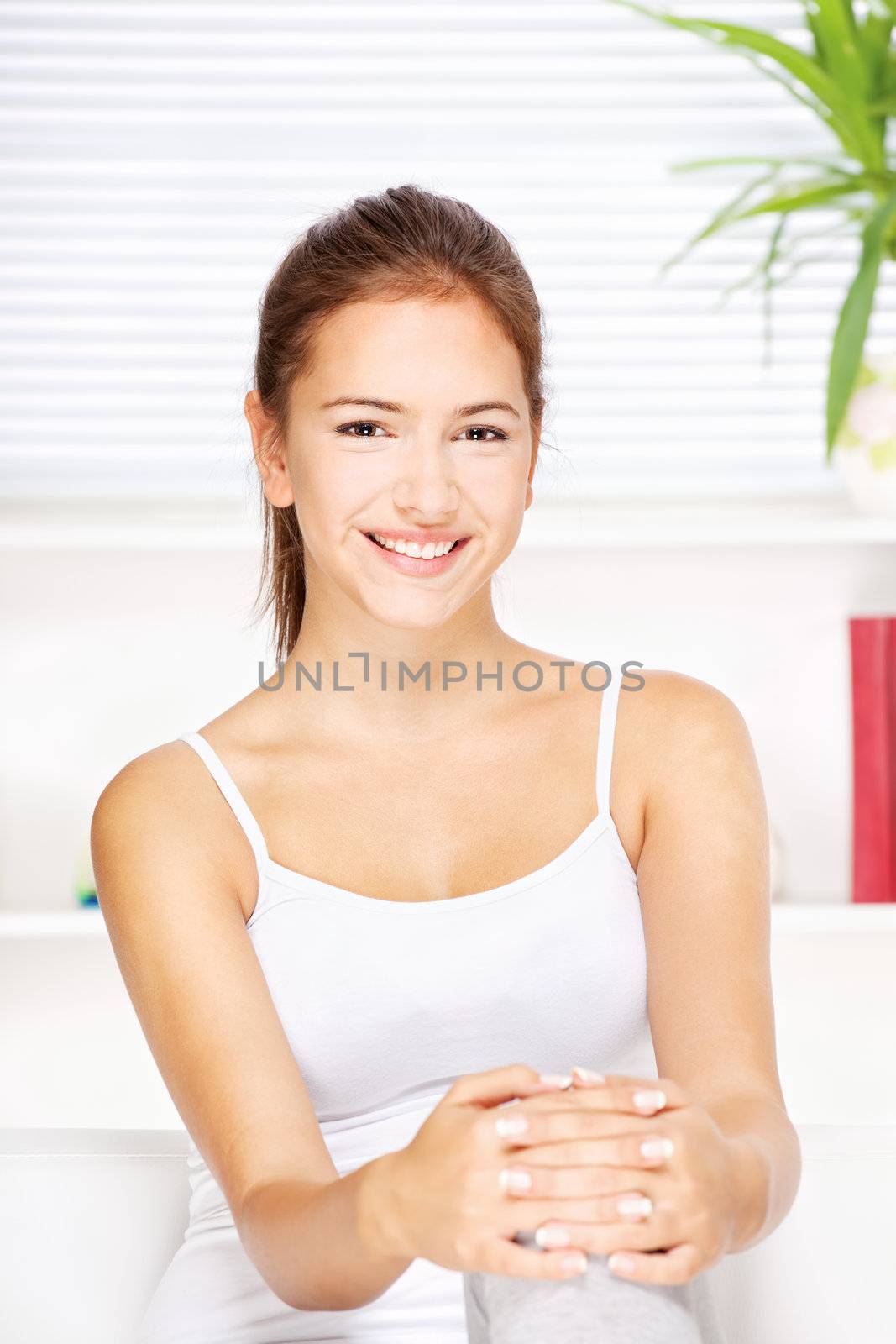 pretty young woman at home sitting on the sofa