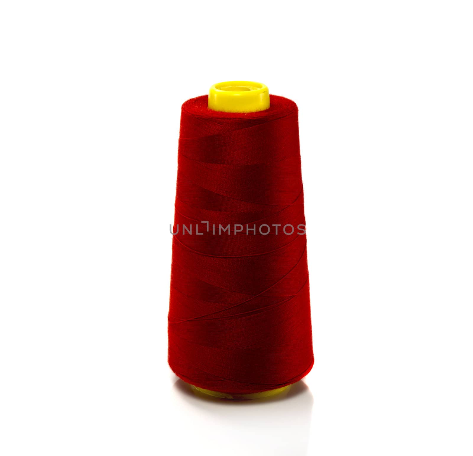red bobbin with thread isolated on white