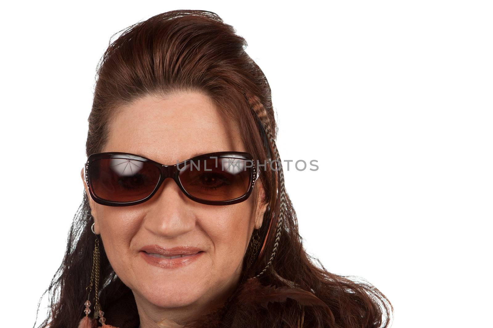 Brunette middle aged woman with feather hair extensions and accessories.
