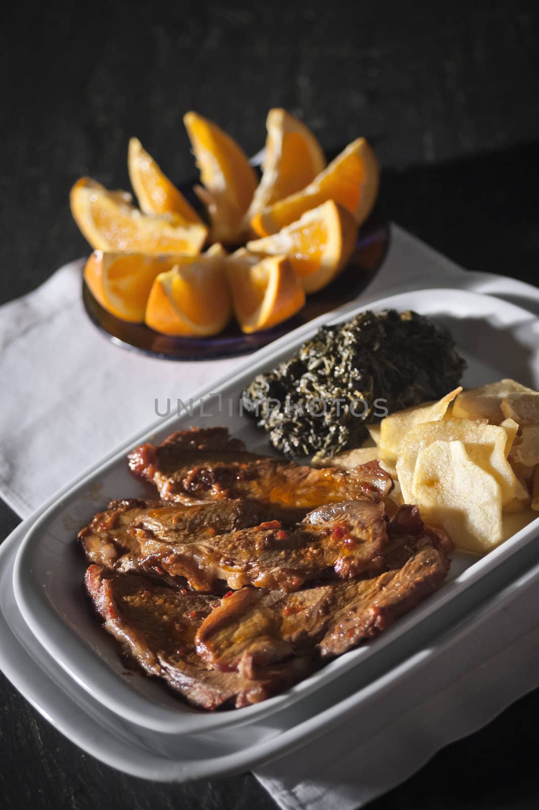 Real food photographed on location in traditional portuguese restaurants, pork fillet seasoned with red bell pepper garnished with mashed spinach, Alentejo, Portugal