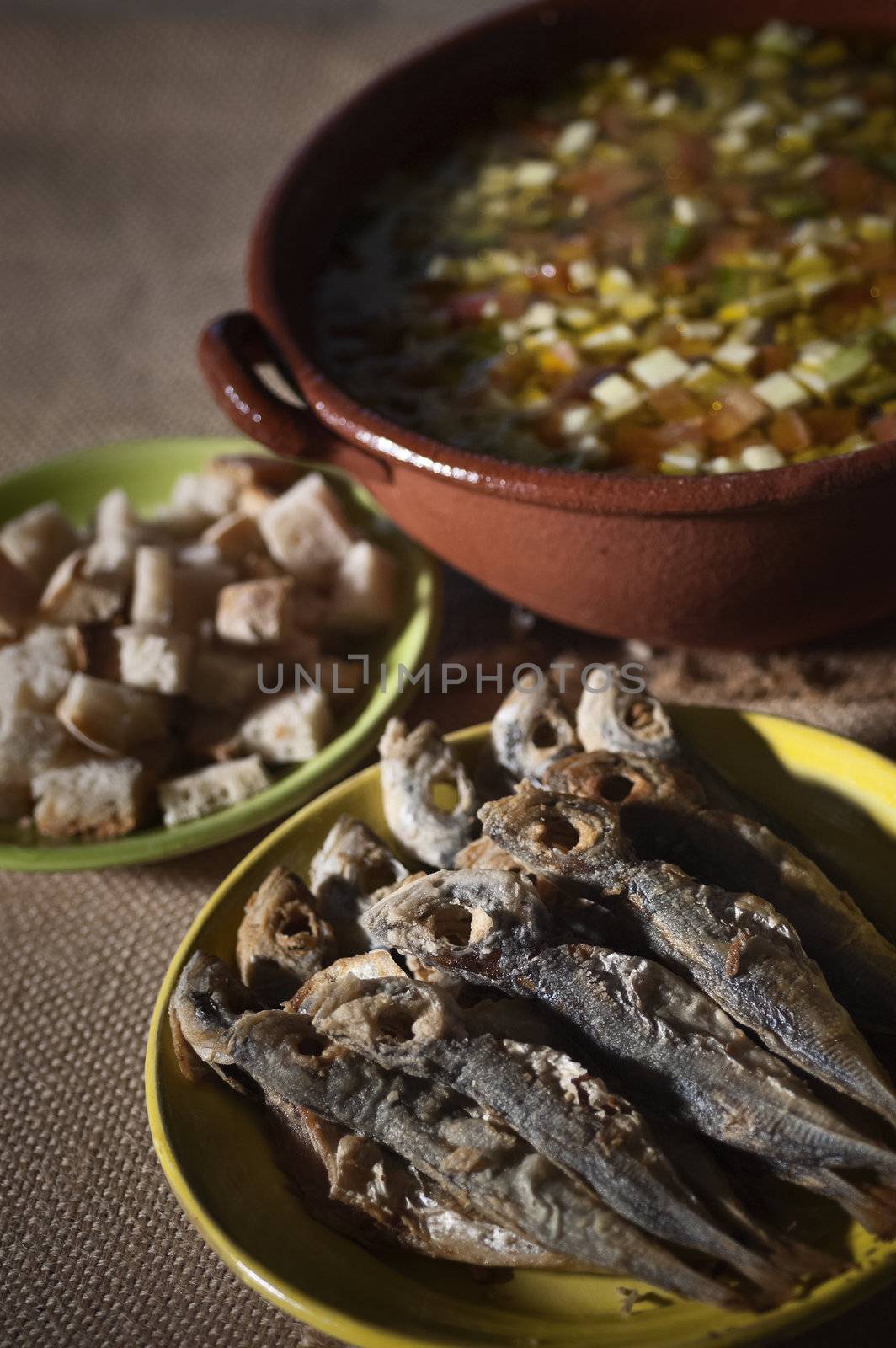 Real food photographed on location in traditional portuguese restaurants, cold soup gaspacho with fried horse mackerel - gaspacho com carapaus fritos - Alentejo, Portugal