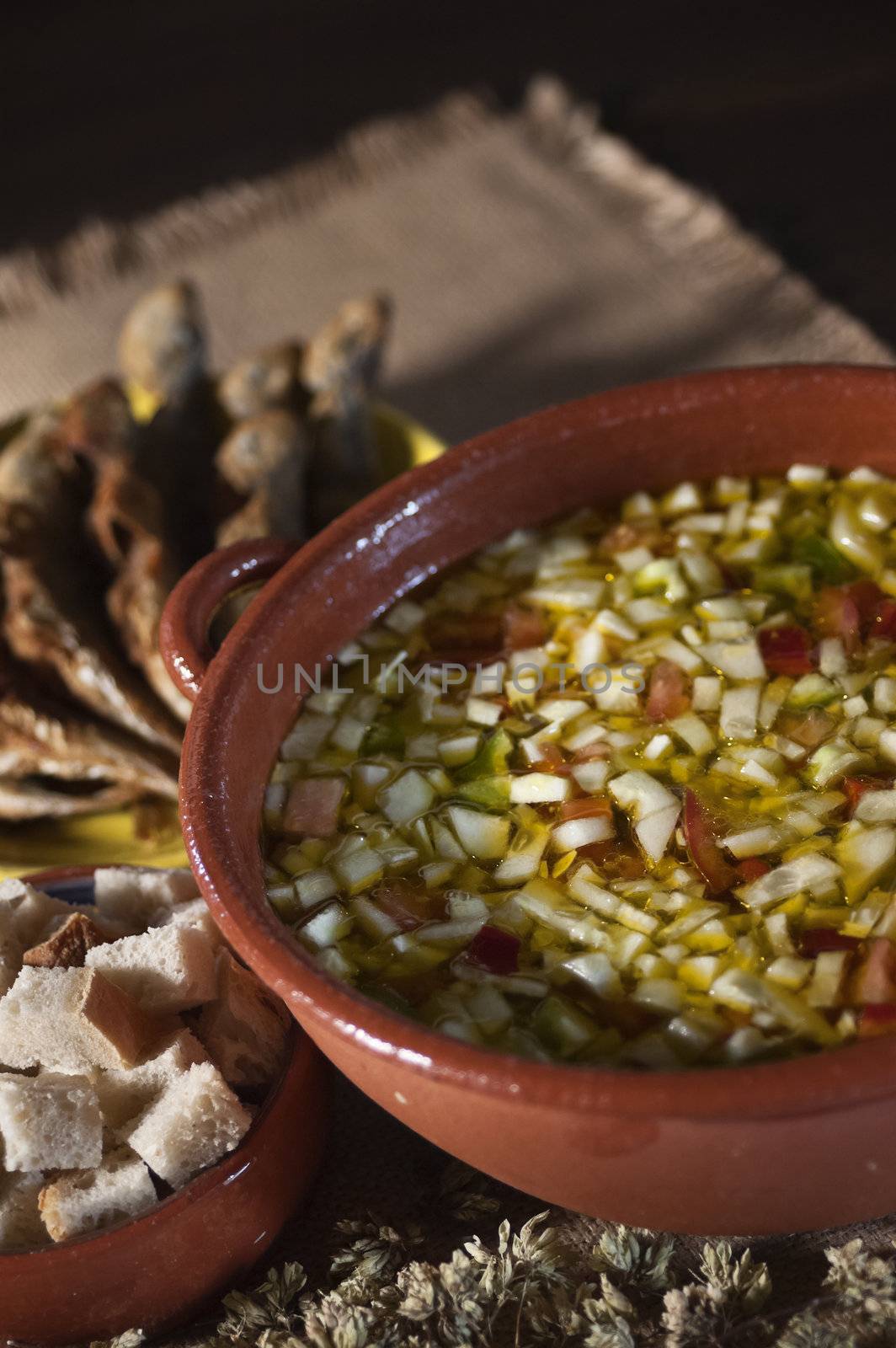 Real food photographed on location in traditional portuguese restaurants, cold soup gaspacho with fried horse mackerel - gaspacho com carapaus fritos - Alentejo, Portugal