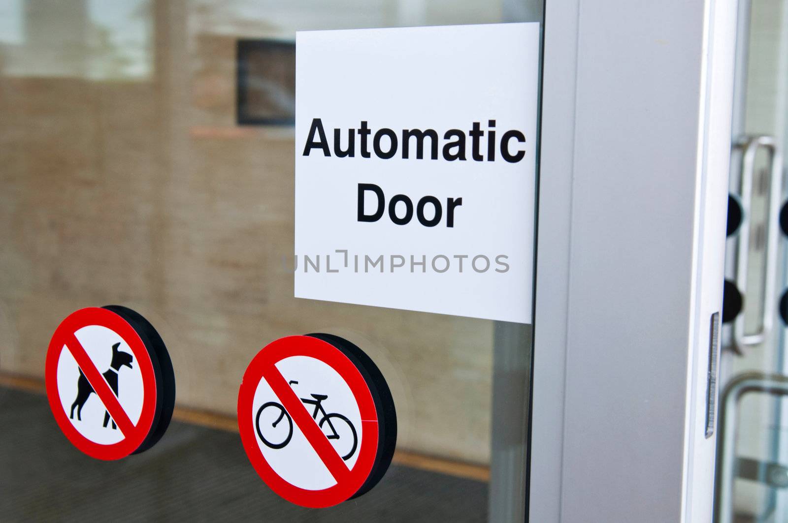 automatic door sign on shopping mall entrance (dogs and bicycles are forbidden)