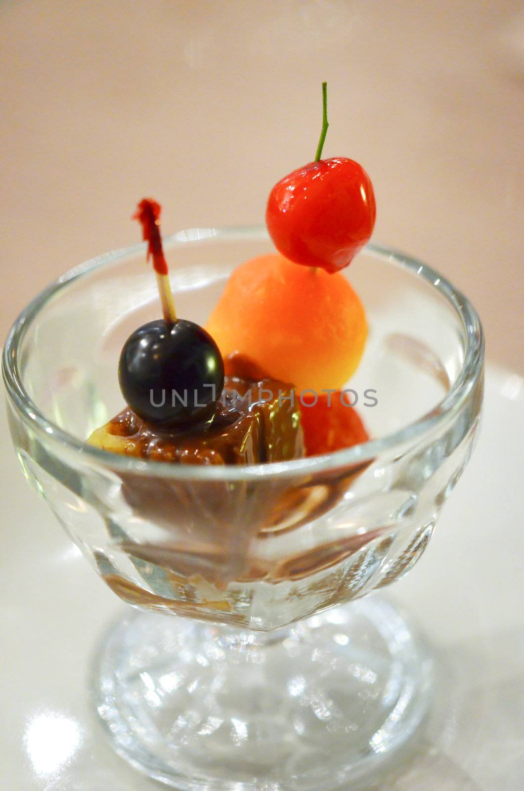 scoop of melon balls , cherry  and fondo chocolate