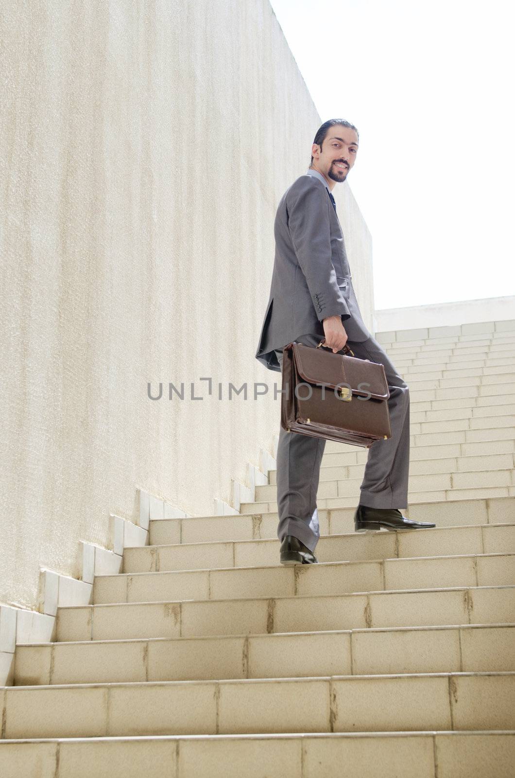 Businessman with stair in business concept by Elnur