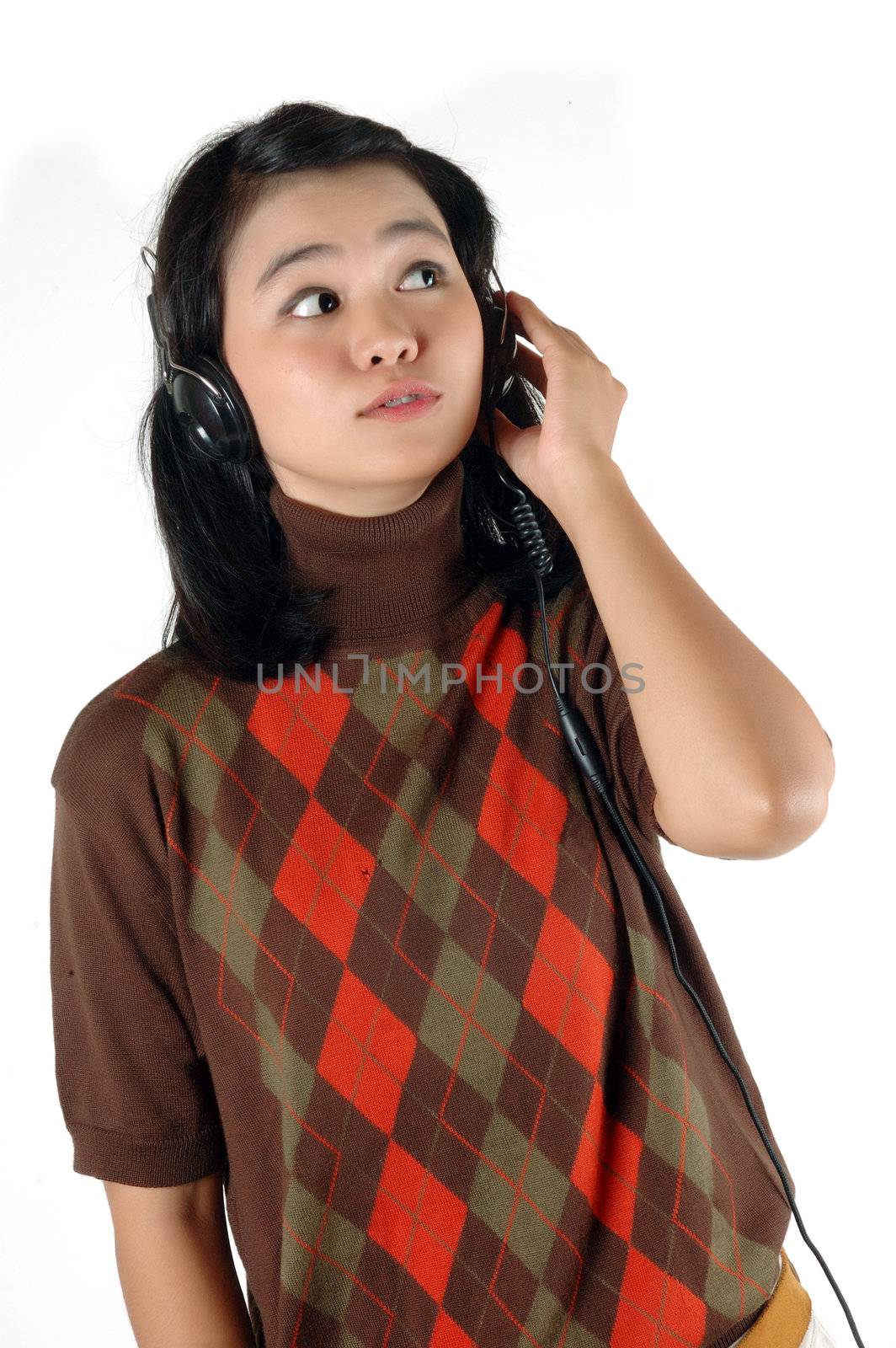 Young woman was listening music with headphone  by antonihalim