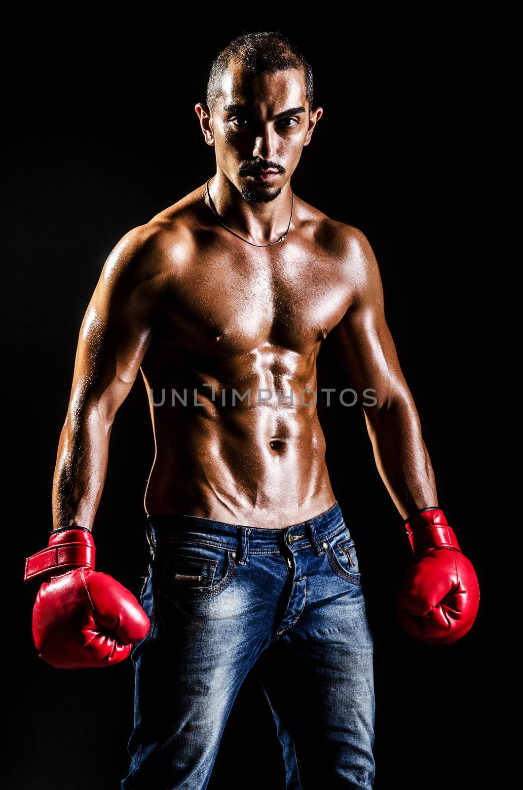 Muscular boxer in studio shooting