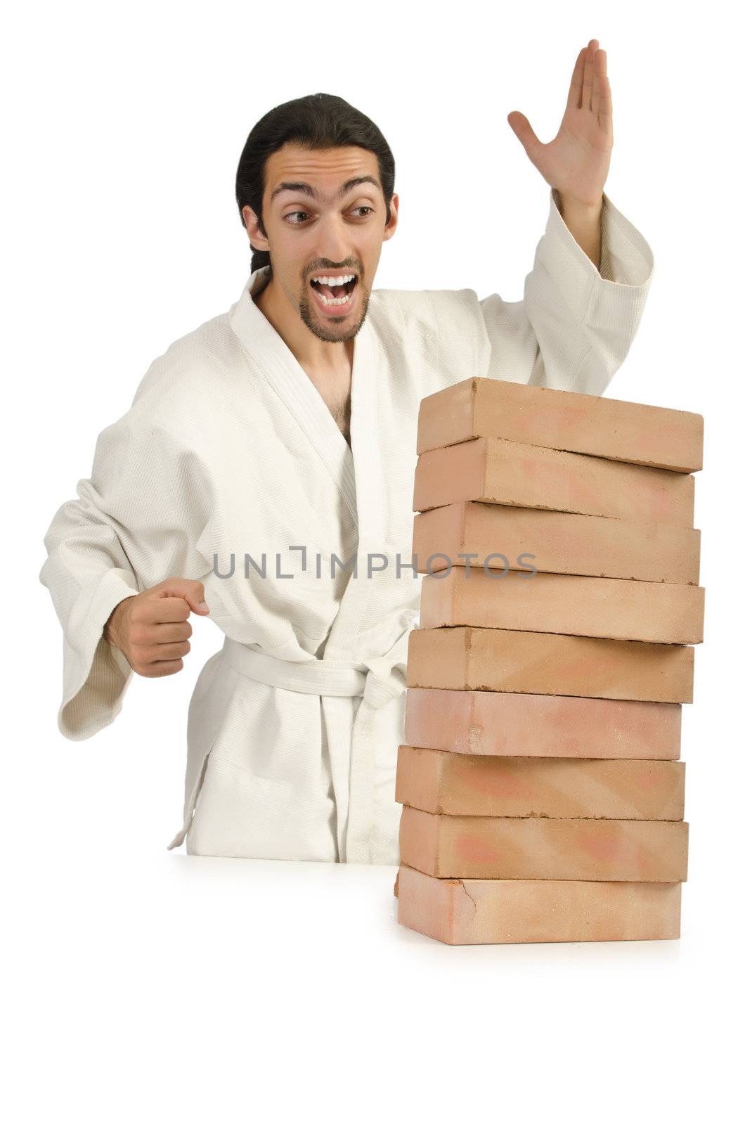 Karate man breaking bricks on white