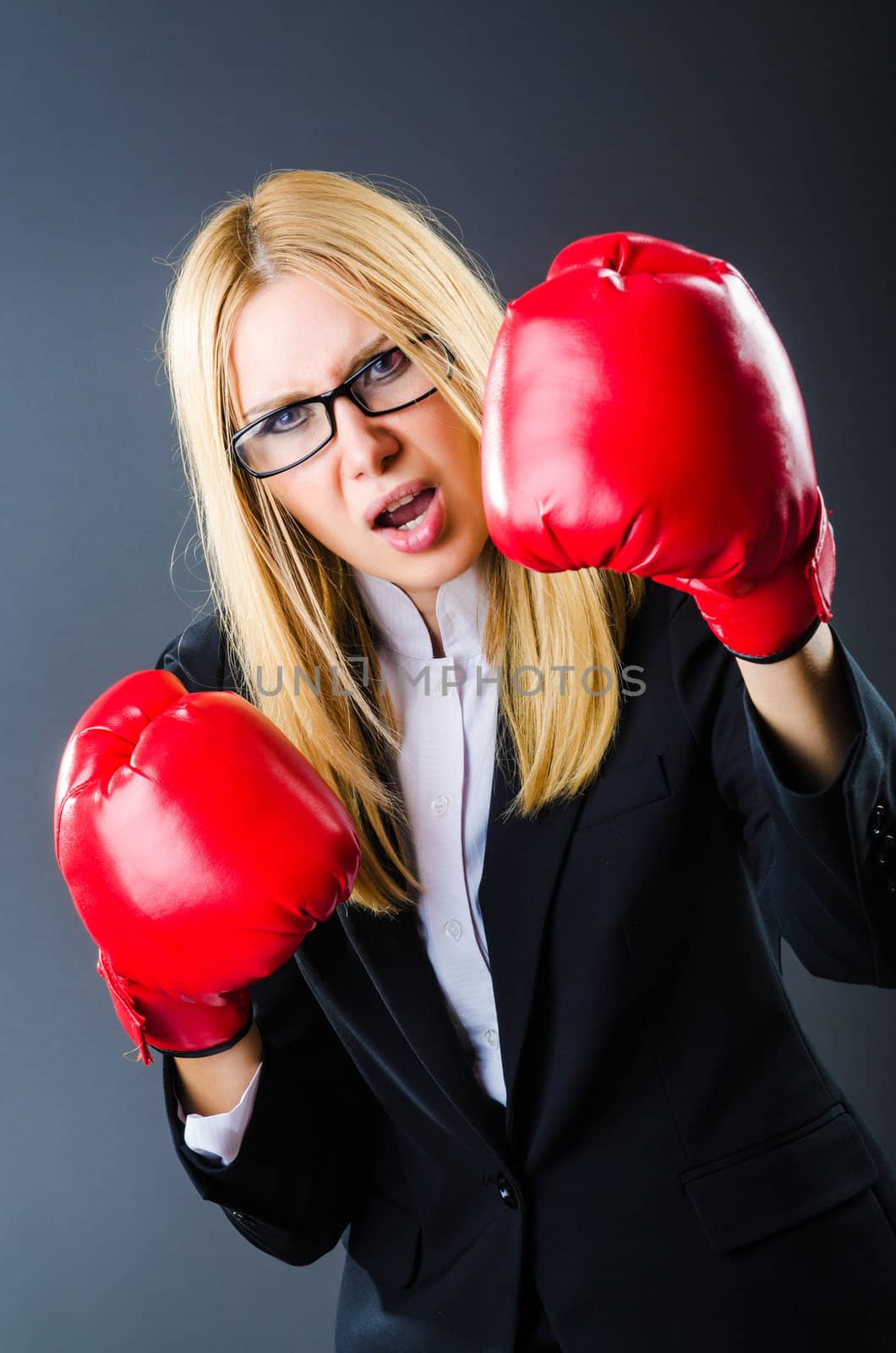 Woman boxer in dark room