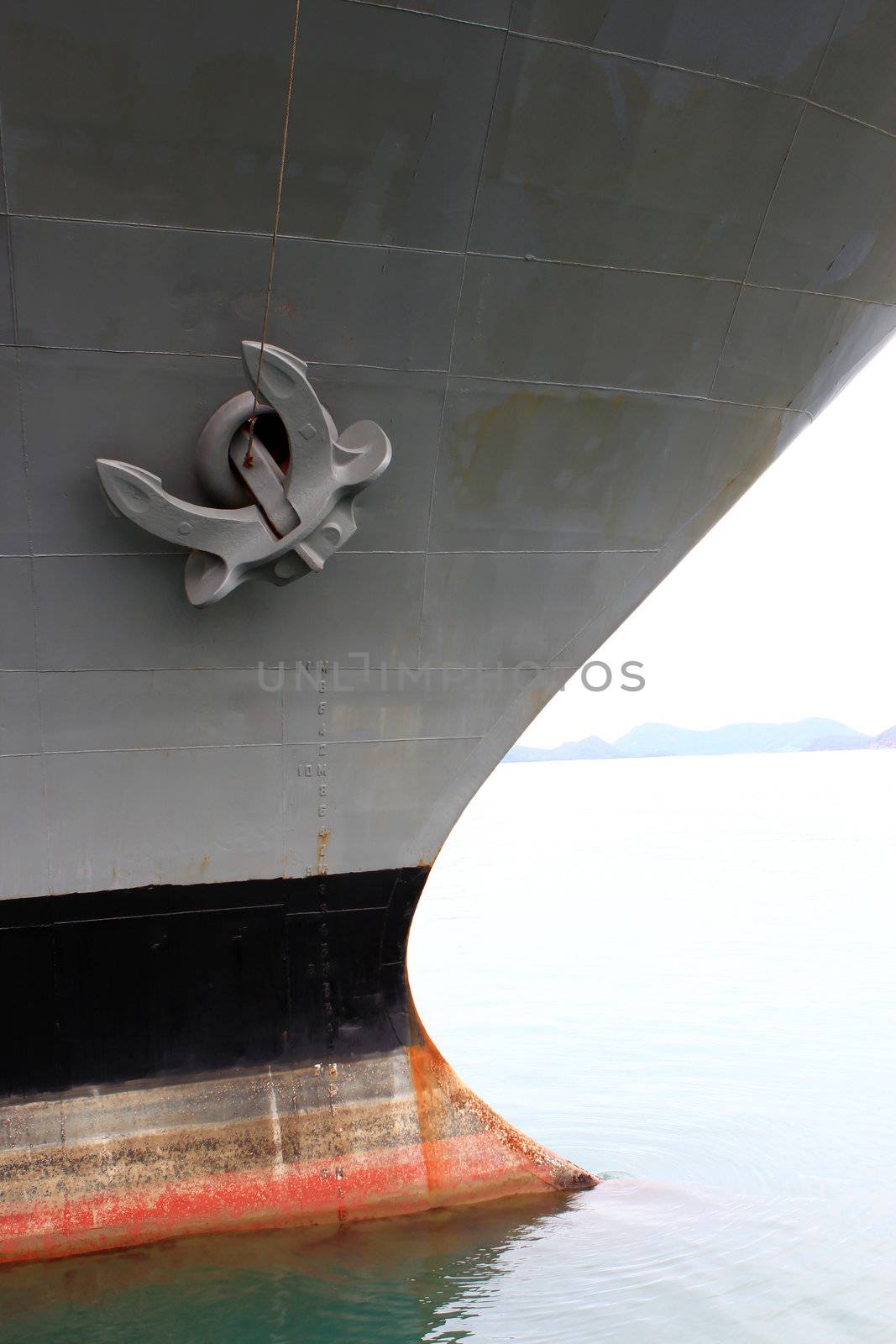 Old anchor on gray background by rufous